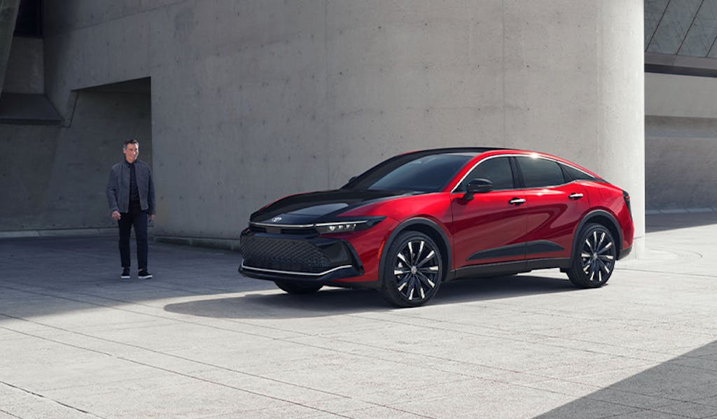 Most Fuel Efficient Toyota Models at Team Toyota of Glen Mills | Man walking up to his new 2024 Toyota Crown in the color red
