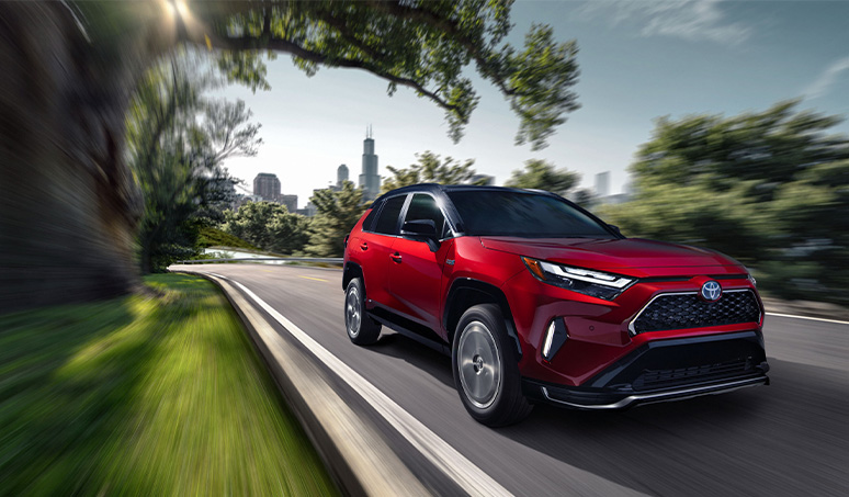 Most Fuel Efficient Toyota Models at Team Toyota of Glen Mills | 2024 Toyota RAV4 driving down a road 