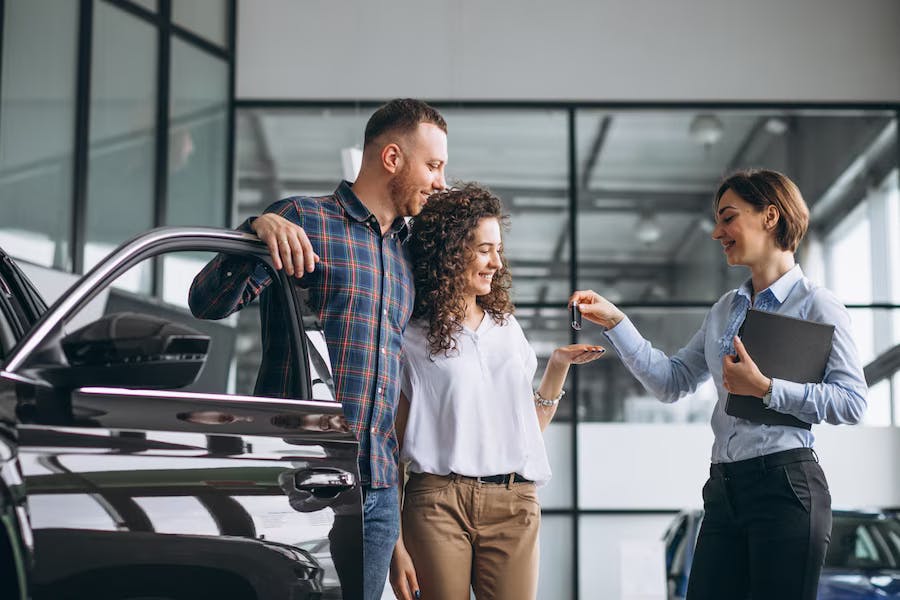 Contact Toyota of Portsmouth salesperson with customer in showroom
