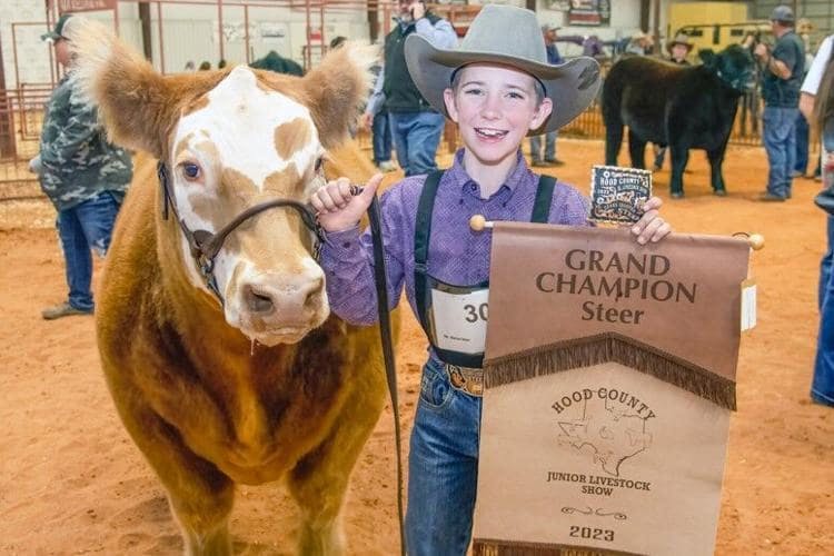 a boy holding a Livestock Sales