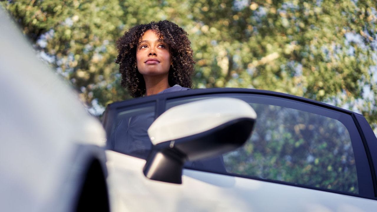 woman looking out of car door