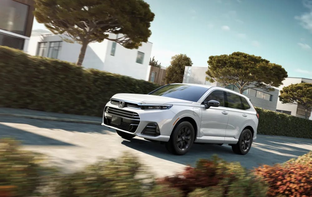 leasing pros and cons blog head Honda SUV Driving through neighborhood