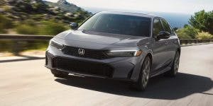 2025 Honda Civic Gray driving down a road