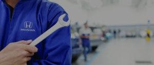 honda tech holding wrench Honda Service Team Member holding a wrench
