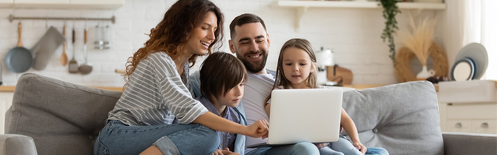 family smiling on couch